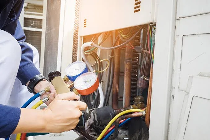 Stock photo of HVAC pressure gauges connected during system maintenance